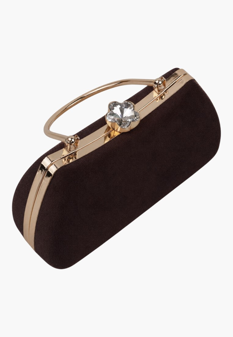 Detail close-up of a brown handbag with gold hardware and zipper closure on a white background.