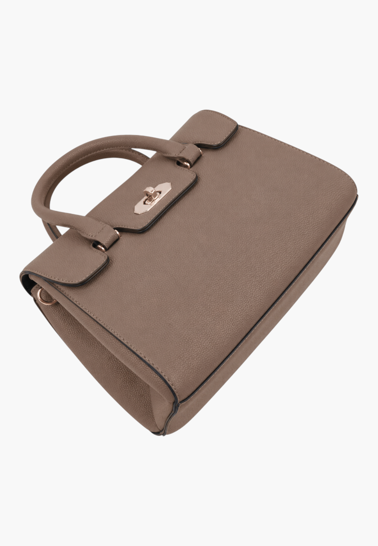 Side view of a brown handbag with a top handle and flap closure on a white background.