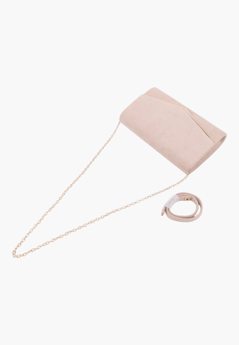 Lifestyle view of the elegant beige faux leather clutch bag with gold chain strap.