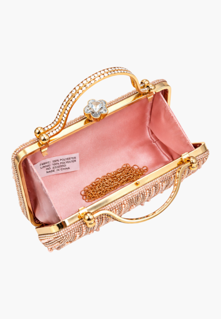 Detail close-up of the pink handbag featuring fringe design and decorative clasp.