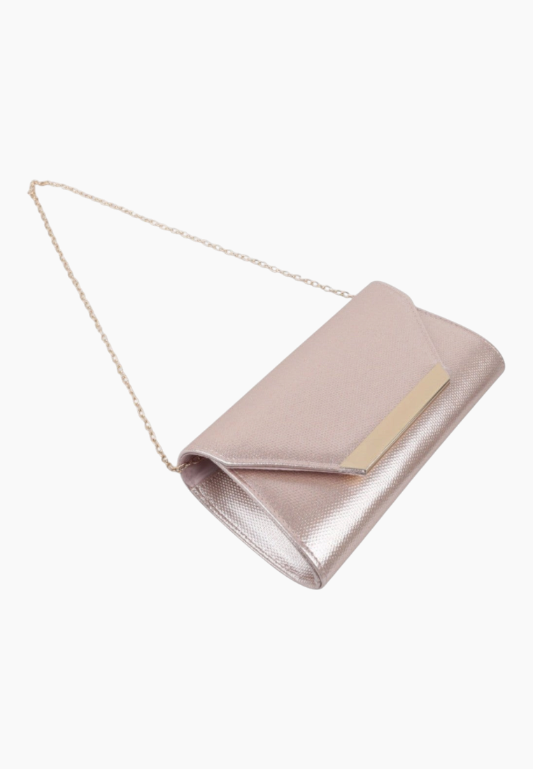 Side view of the pink and gold clutch bag with fold-over flap on a white background