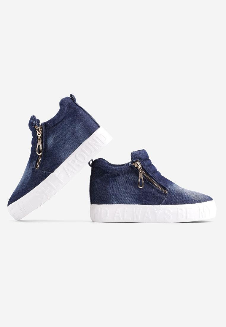 Bok niebieskich sneakersów damskich z białą podeszwą.