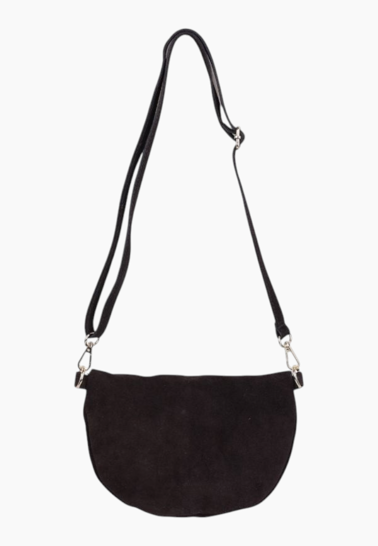 Detail close-up of the black suede handbag showing its rounded shape and zipper closure.