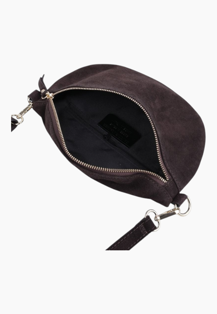 Detail close-up of the black suede handbag showing the interior view and zipper closure.
