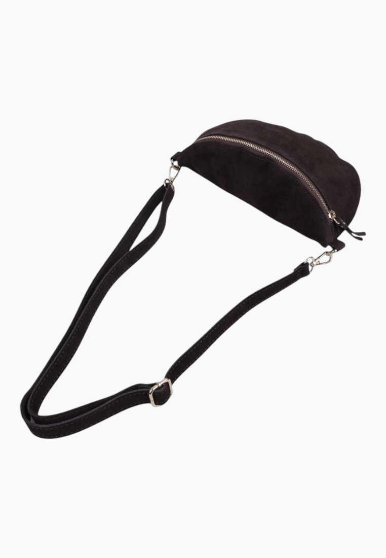 Lifestyle shot of the black suede handbag with a long strap and zipper closure on a white background.