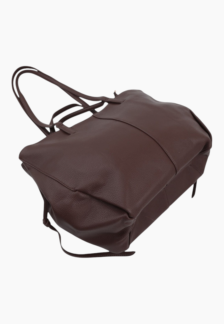 Detail close-up of a brown tote bag showcasing its soft material and two handles.