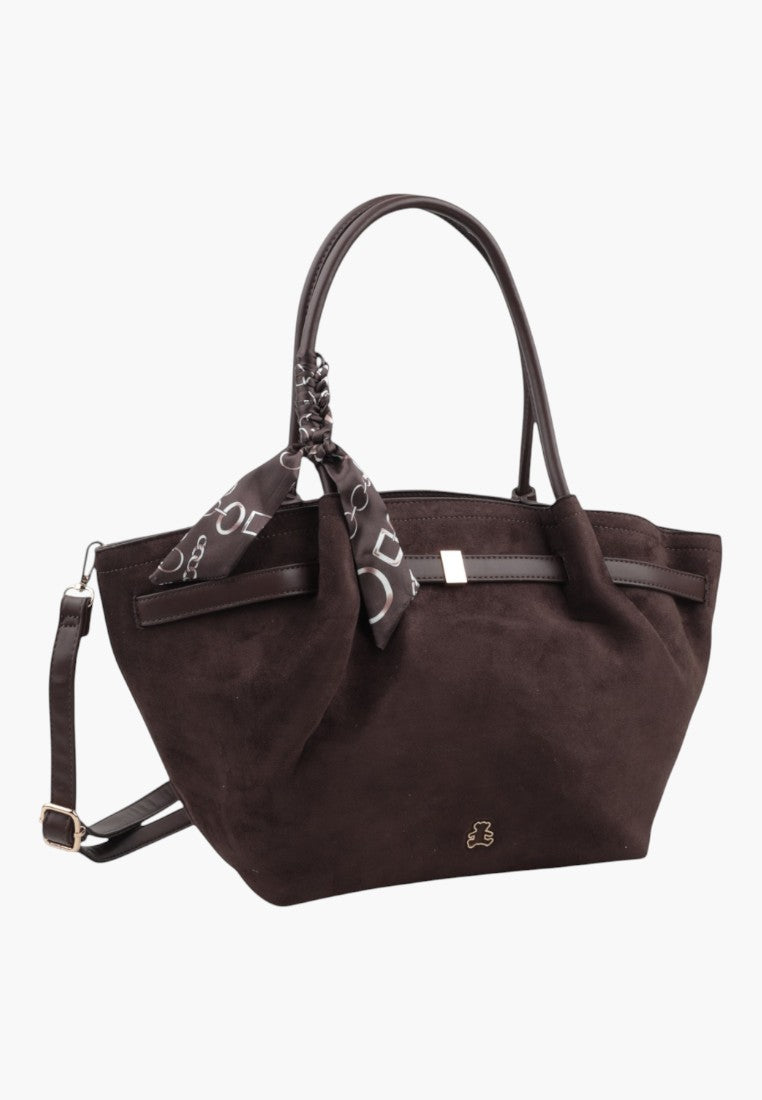 Lifestyle shot of a dark brown faux suede shopper bag with a decorative scarf.