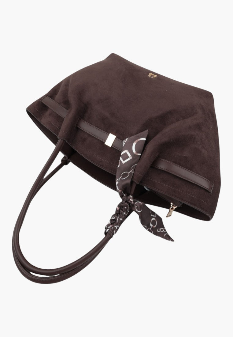 Side view of a brown faux suede shopper bag with shoulder straps and decorative scarf.