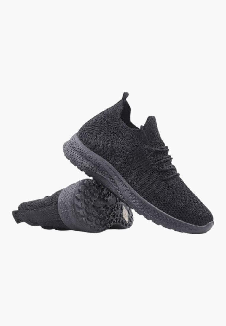 Side view of black athletic shoes featuring textured sole and cushioned heel