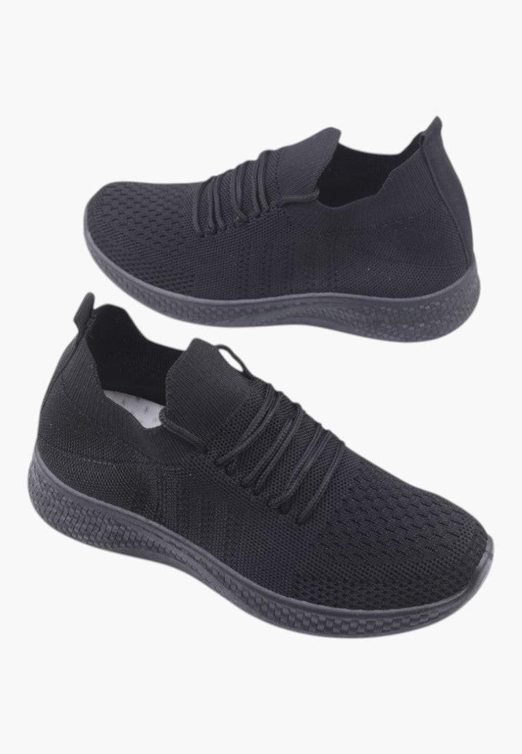 Top view of black athletic shoes with elastic bands and minimalist design