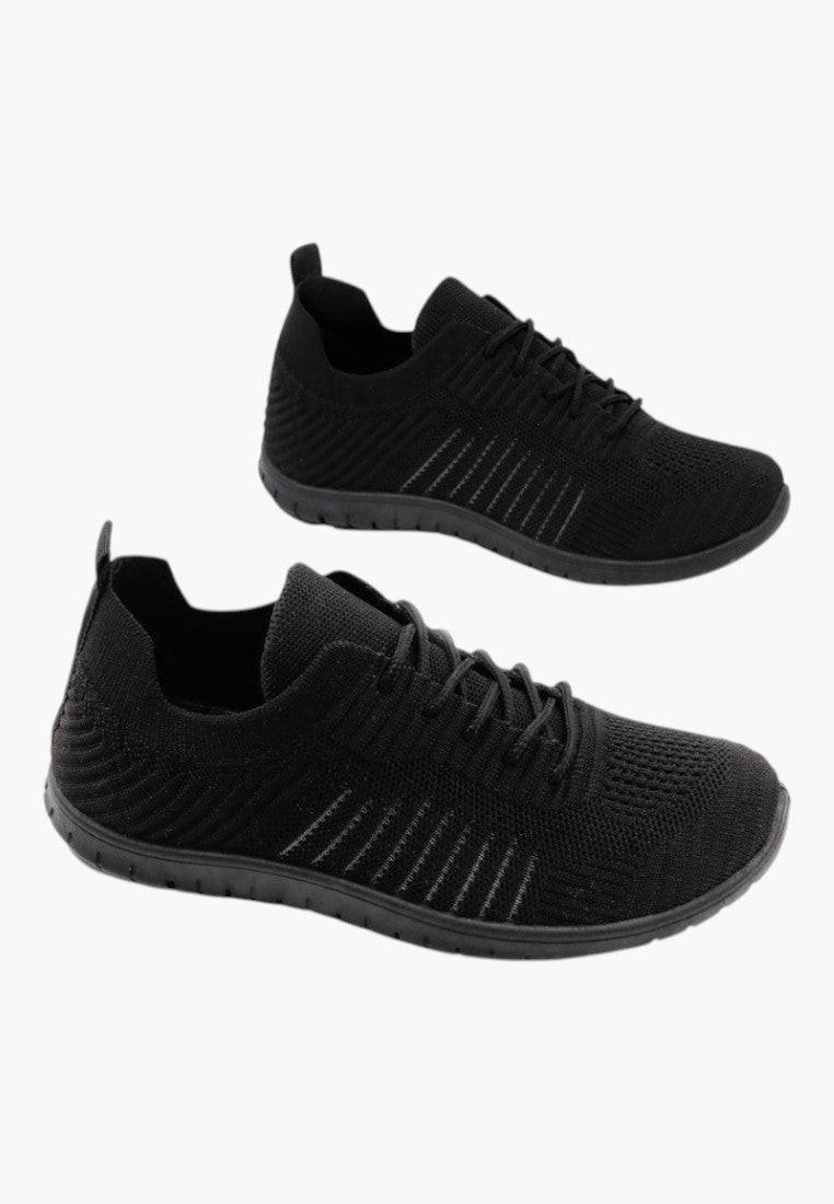Czarne buty sportowe w minimalistycznym stylu, widok lifestyle.