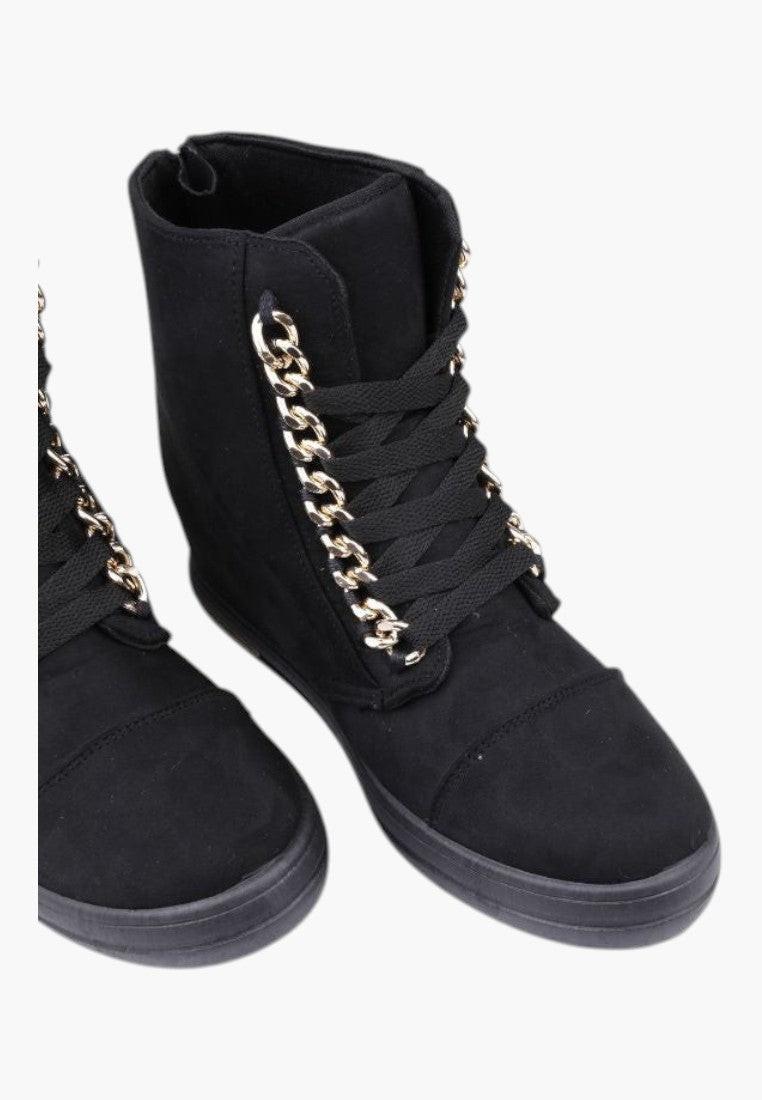 Widok z bliska czarnych sneakersów botków damskich z miękkiego materiału.