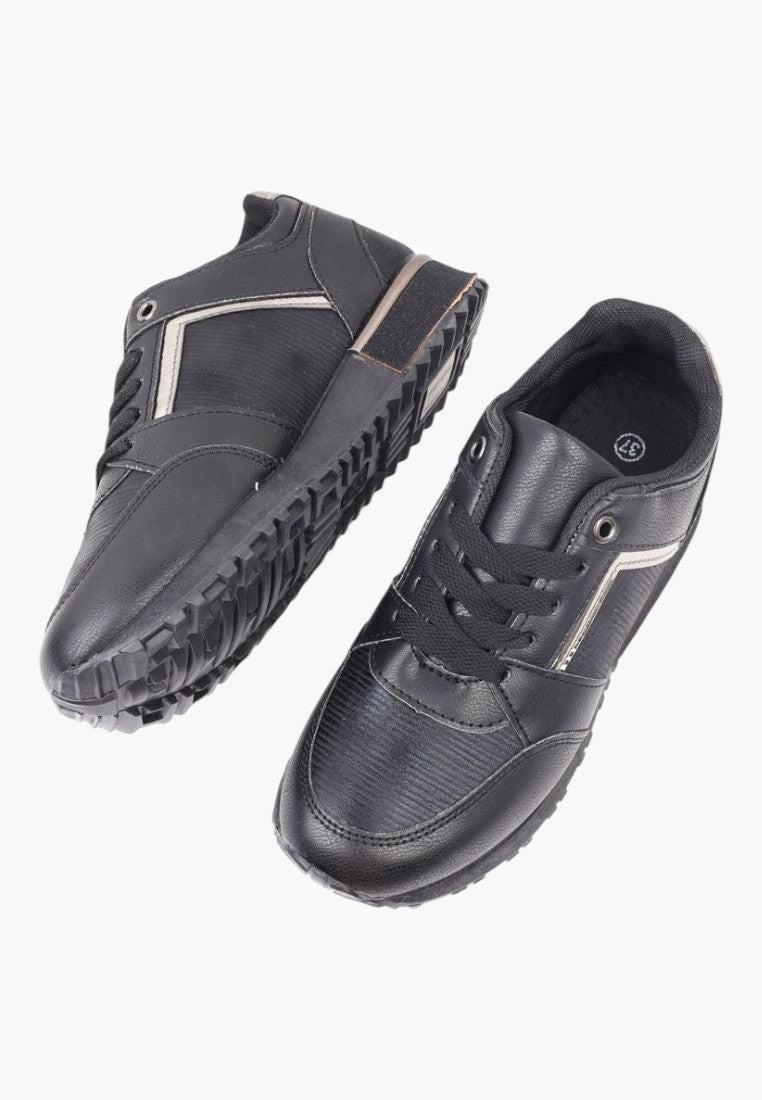 Zbliżenie na detal czarnych sneakersów damskich z nowoczesnym wyglądem.