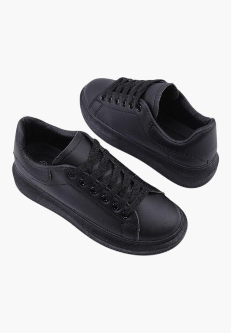 Textured upper of black women's sneakers in a casual style on a white background