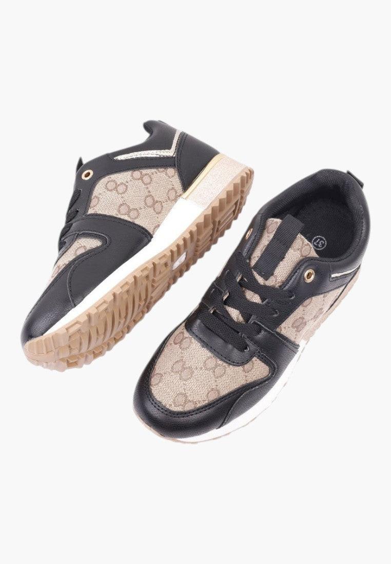 Detal teksturowanego wierzchu czarno złotych sneakersów damskich