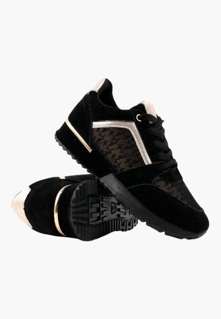 Czarno złote sneakersy damskie w stylowym otoczeniu, widok lifestyle.