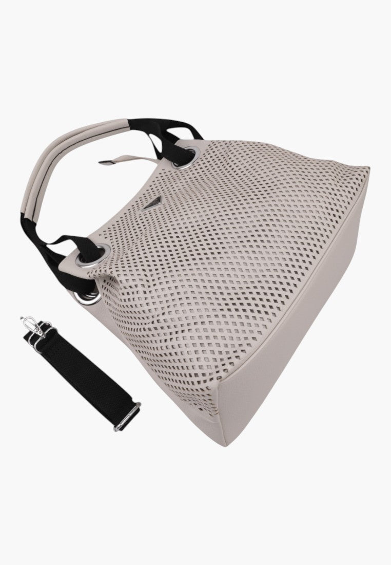 Close-up of the textured surface of the beige handbag with a detachable strap on a white background.