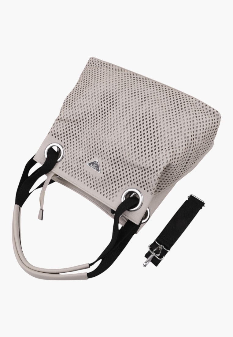 Side view of the beige handbag with a detachable strap and two handles on a white background.