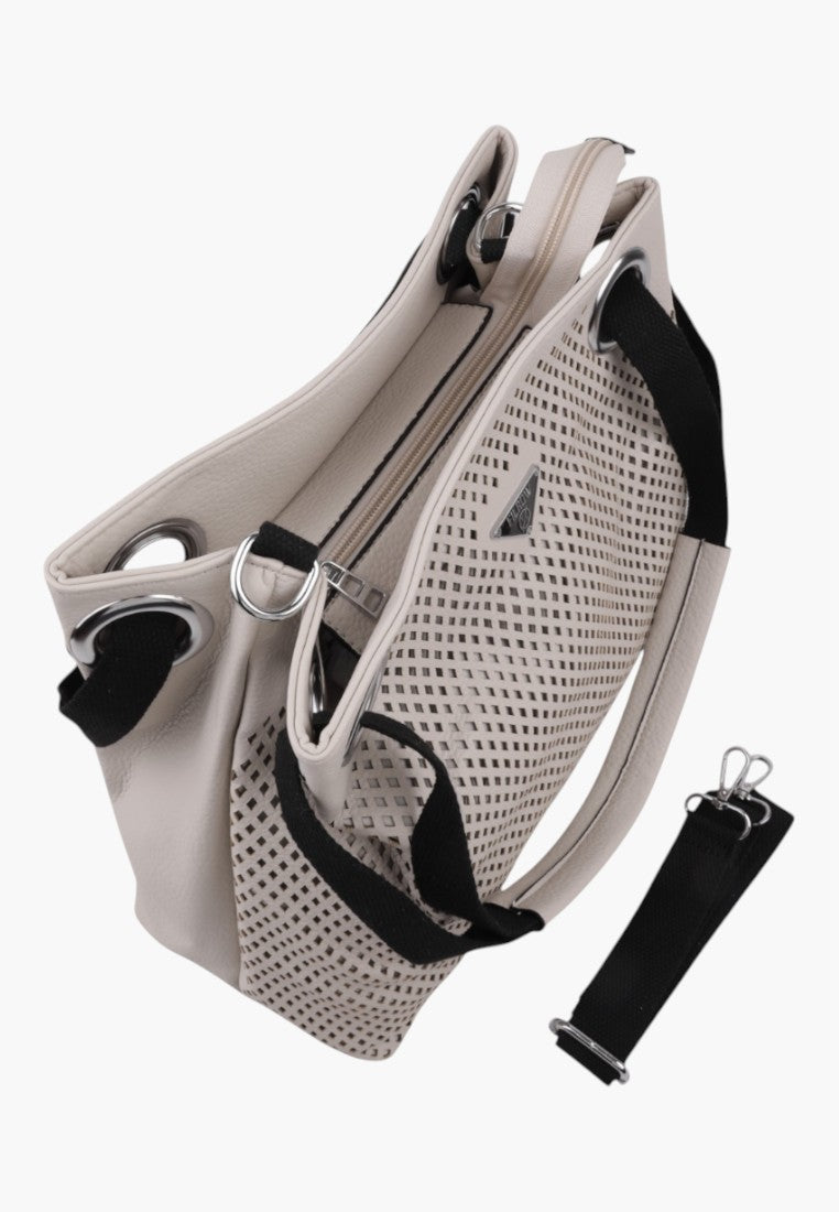 Side view of the beige handbag showcasing a zipper closure and adjustable strap on a white background.