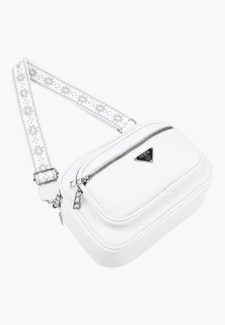 Lifestyle shot of a white handbag showcasing zipper closure and logo detail.
