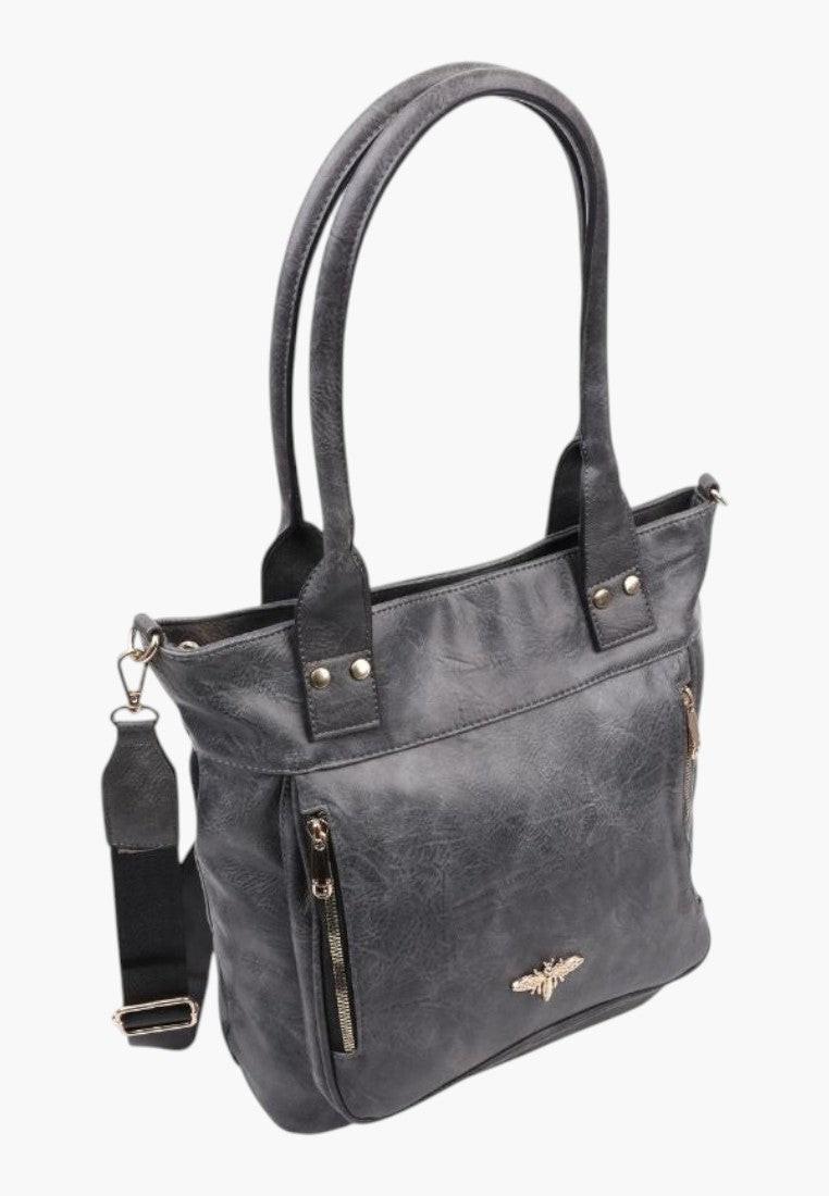 Boczny widok eleganckiej szarej torebki shopper na ramię z ekoskóry z odpinanym paskiem.