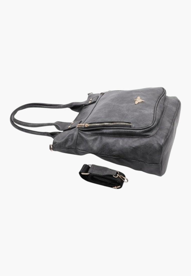 Boczny widok wnętrza eleganckiej szarej torebki shopper na ramię z ekoskóry z wieloma kieszeniami.