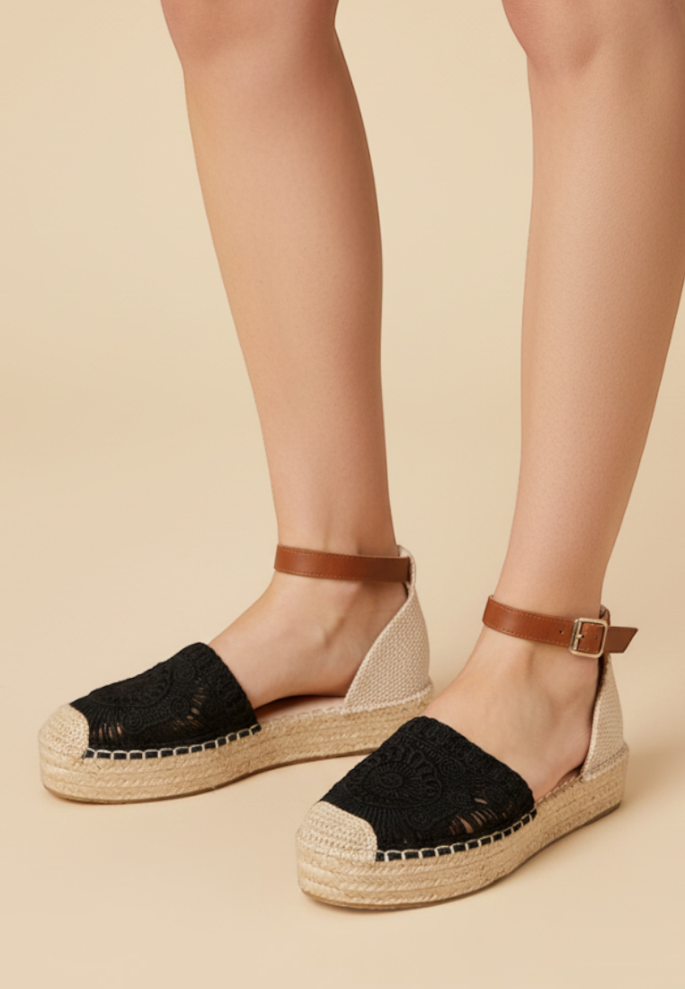Falio women's platform espadrille sandals featuring black crochet toe, beige heel, and brown ankle strap with buckle.