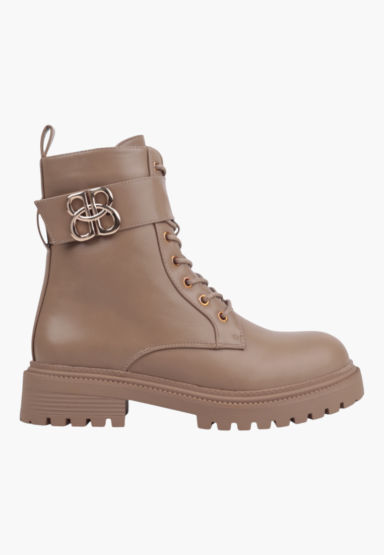 Falio beige ankle boots with a chunky lug sole, lace-up front, and a decorative gold buckle strap detail.