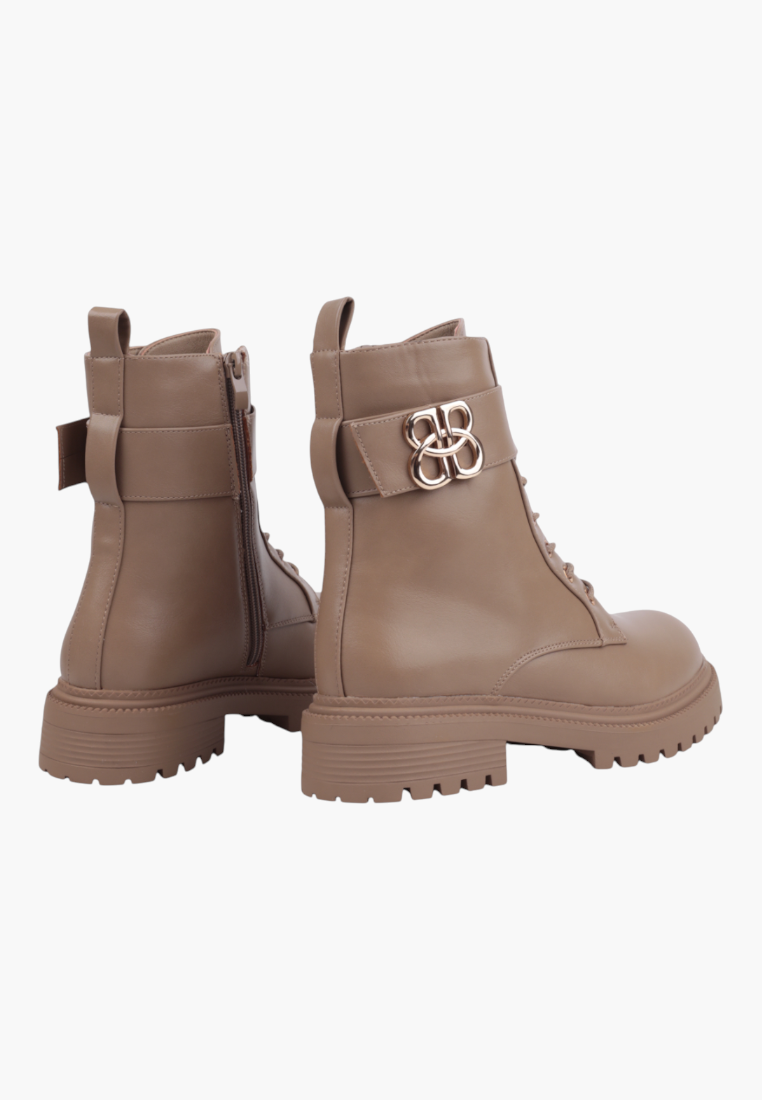 Falio beige ankle boots with a chunky lug sole, side zipper, and gold-tone decorative buckle detail