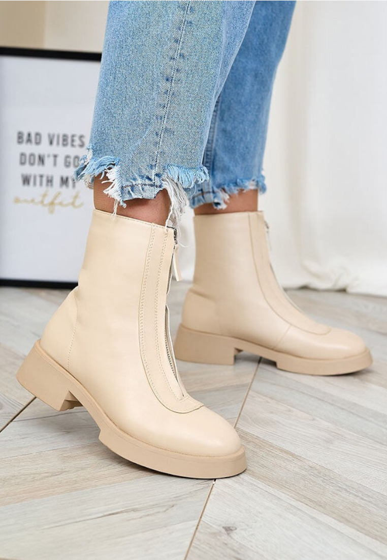 Falio beige faux leather ankle boots with front zipper closure worn with frayed blue jeans
