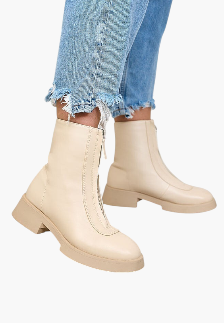 Falio beige faux leather ankle boots with front zipper and thick sole worn with frayed blue jeans