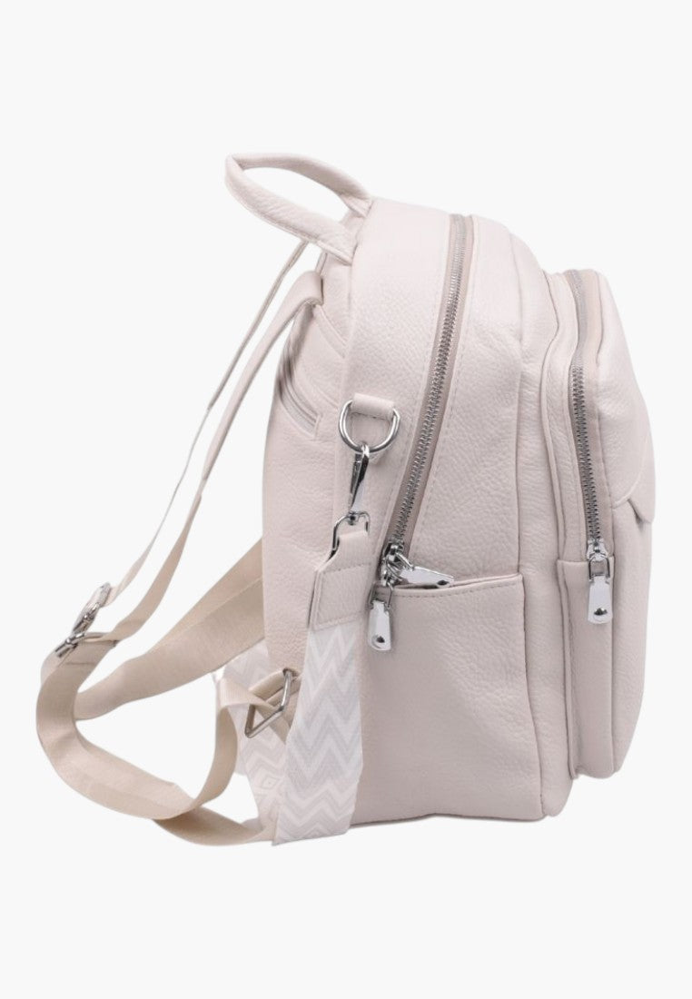 Falio multi-compartment urban backpack in beige faux leather with silver zippers and patterned shoulder straps