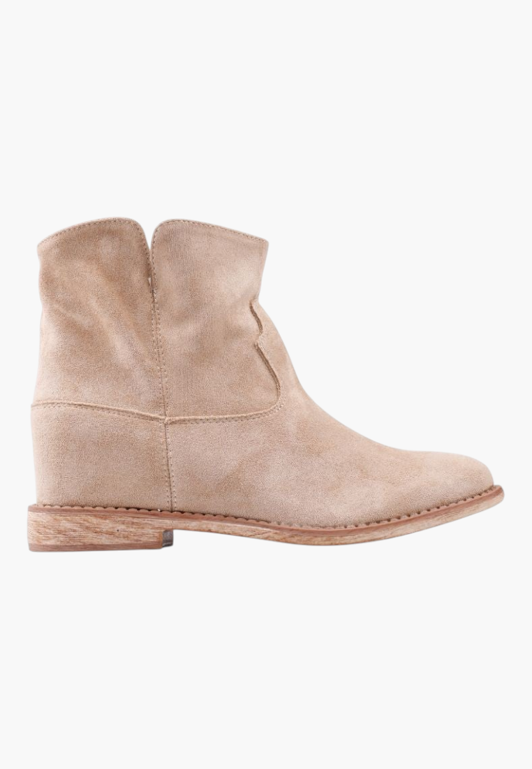 Falio beige faux suede ankle boots with a hidden wedge heel and rounded top, perfect for a western-inspired look.