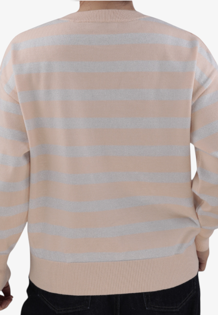Falio beige and silver striped pullover sweater with long sleeves and a crew neck, worn over dark jeans.