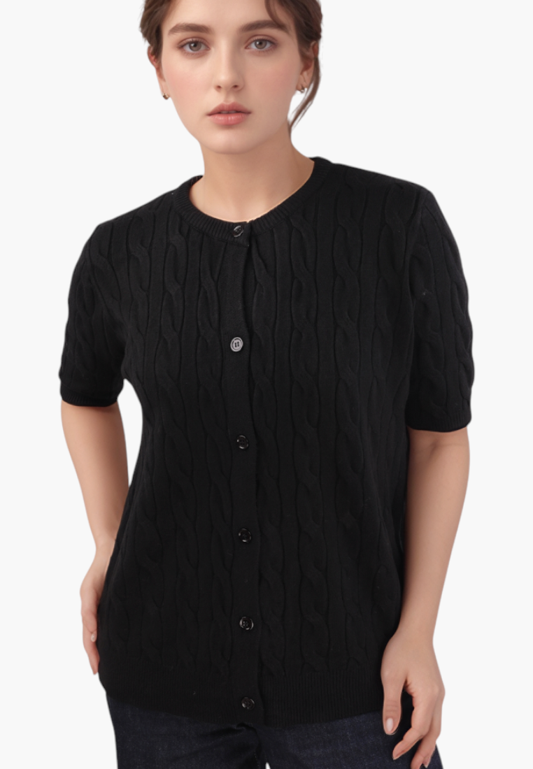 Model wearing a black Falio short-sleeve button-up cardigan with a cable knit pattern and round neckline.