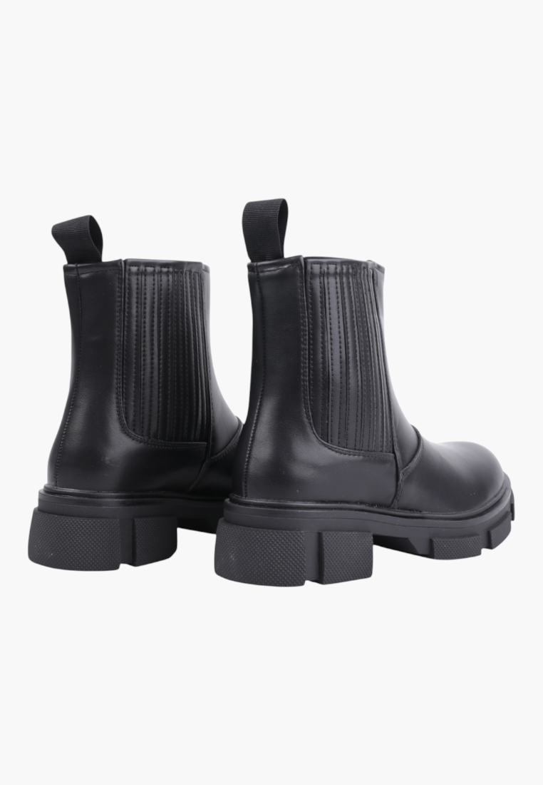 Falio black ankle boots with a chunky lug sole and elastic side panels, shown from a rear angle.