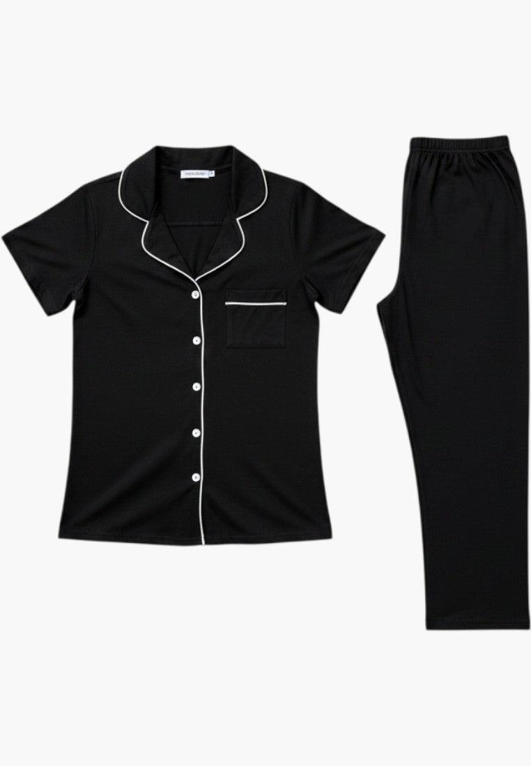 Falio black cotton pajama set with white piping, short sleeves, and 3/4 length pants.