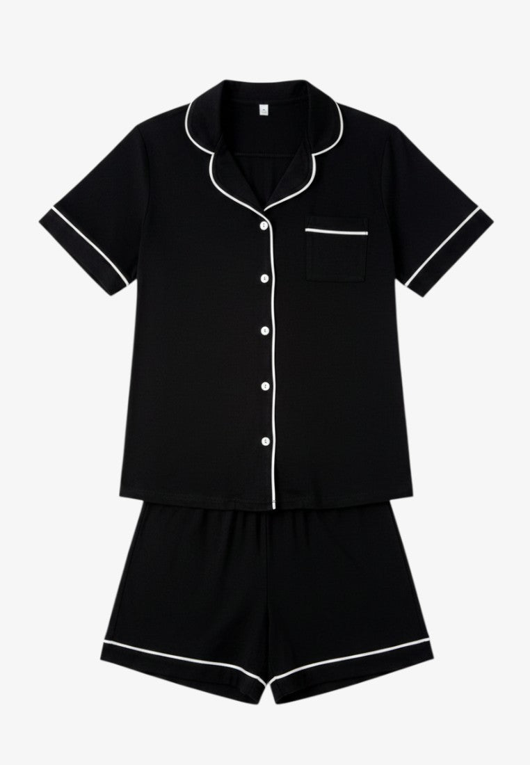 Falio black cotton pajama set with short sleeves, button-down top, and white piping trim details.