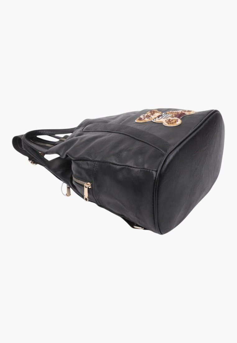 Falio small black faux leather urban backpack with a decorative teddy bear patch and gold zipper details