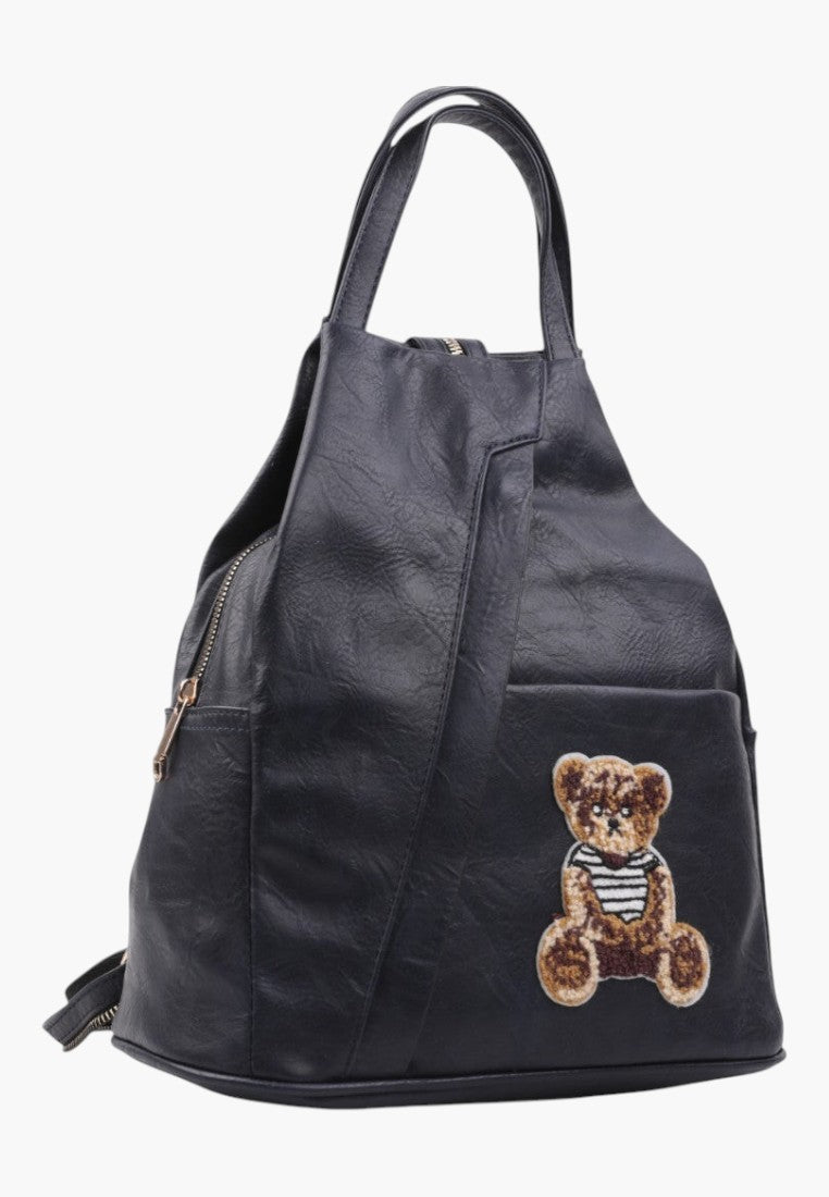 Falio small black faux leather urban backpack with a cute teddy bear patch and zipper closure