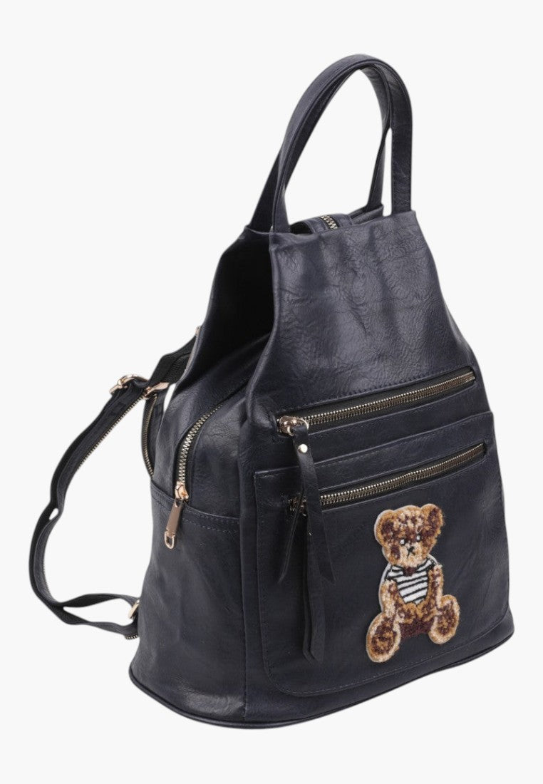 Falio black faux leather urban backpack with multiple zippered pockets and a cute teddy bear patch detail