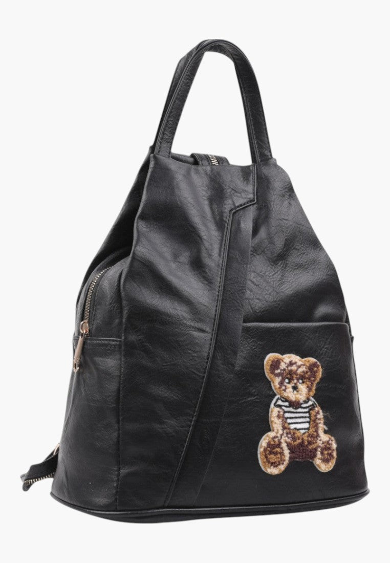 Falio small black faux leather urban backpack featuring a cute embroidered teddy bear patch and zip closure.