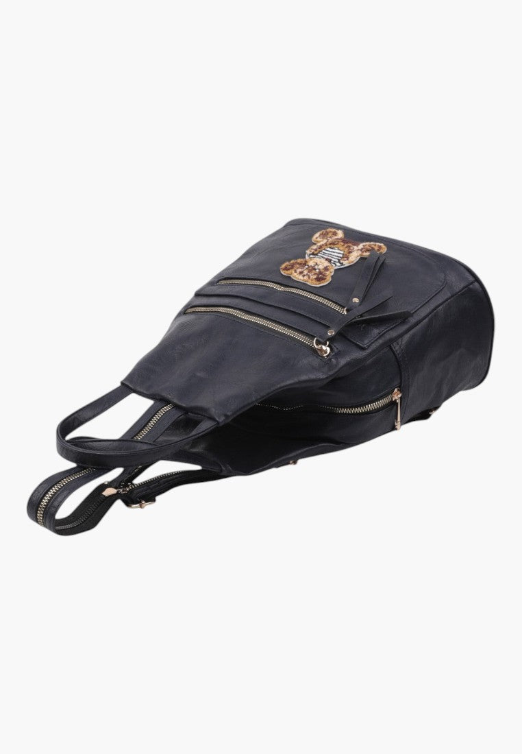 Falio urban women's backpack in black faux leather with a decorative bear patch and multiple zippered pockets
