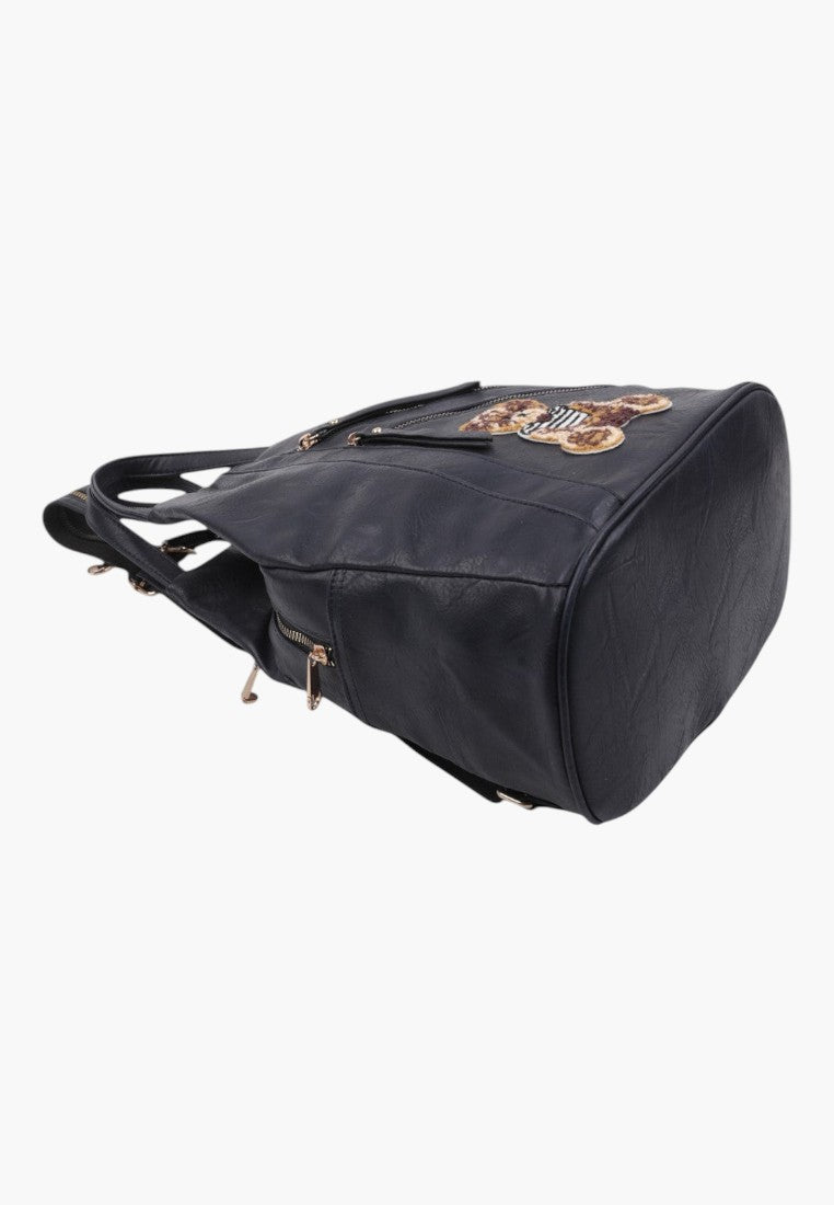 Falio black faux leather urban backpack with a decorative bear patch and multiple zippered pockets