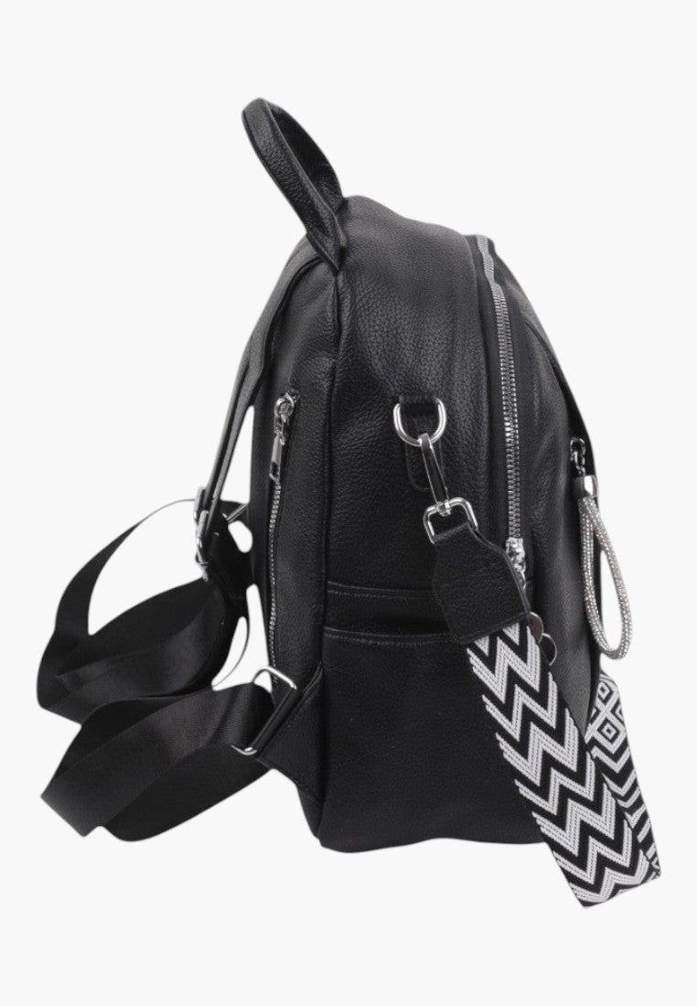Falio black faux leather urban backpack with a patterned chevron strap and silver zippers, side view