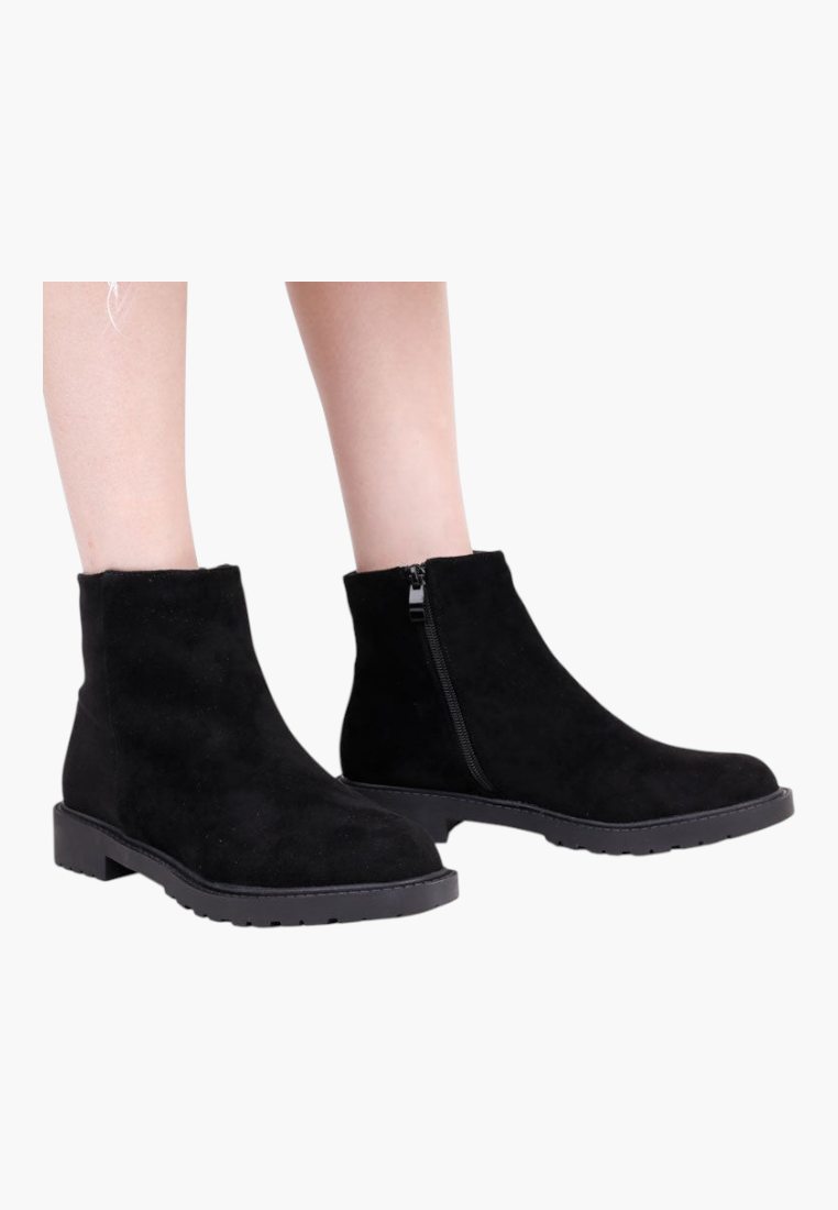 Falio black faux suede ankle boots with a round toe, flat lug sole, and side zipper closure for winter wear