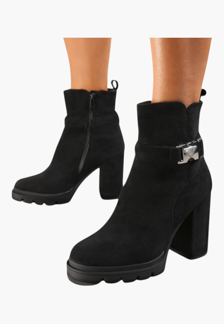 Falio black faux suede ankle boots with a chunky block heel, side zipper, and decorative silver buckle detail.