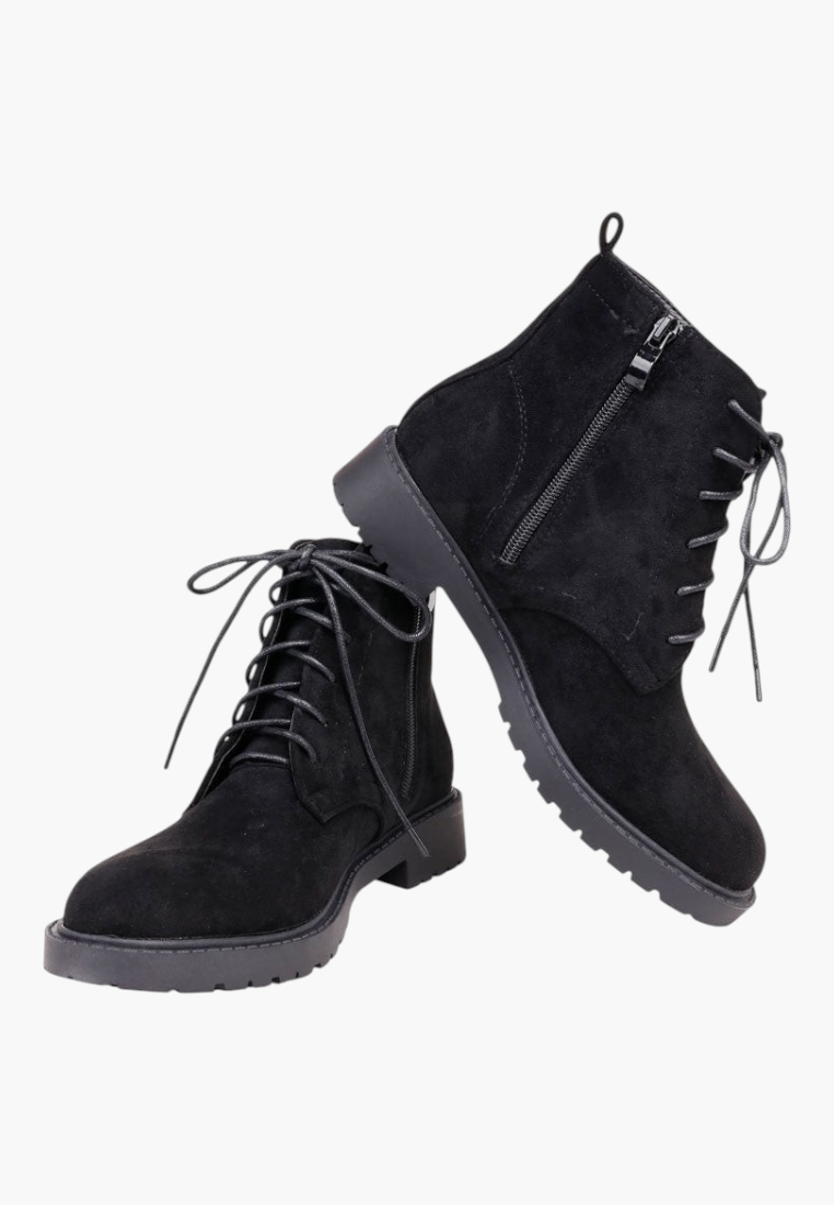 Falio black faux suede ankle boots with flat soles, side zippers, and front lace-up closure.