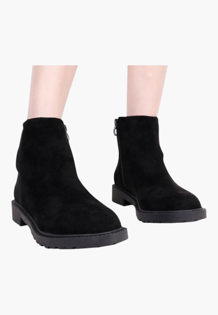 Falio black faux suede ankle boots with a round toe, side zipper, and flat lug sole for winter wear.