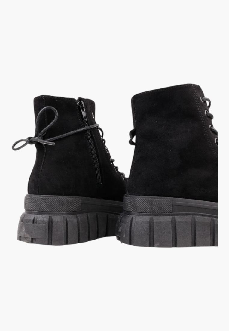 Falio black faux suede ankle boots with thick platform soles, side zippers, and lace-up front for winter wear.